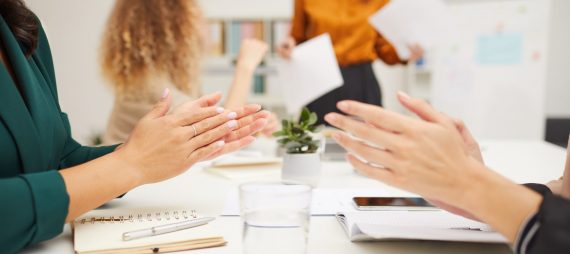 Unrecognizable businesswomen clapping hands after their colleagues presentation